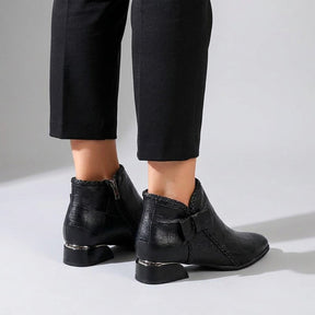 Rear three-quarter view of Tamsin boots showing the silver heel band and braided trim