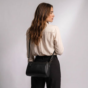 Back view of the Odalys bag worn by the model, showing the rear zip pocket
