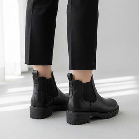 Rear three-quarter view of Ines Chelsea boots showing the pull loops and block heels