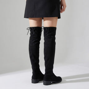 Back view of Oriane over-the-knee boots worn with a short skirt, drawstring ties visible