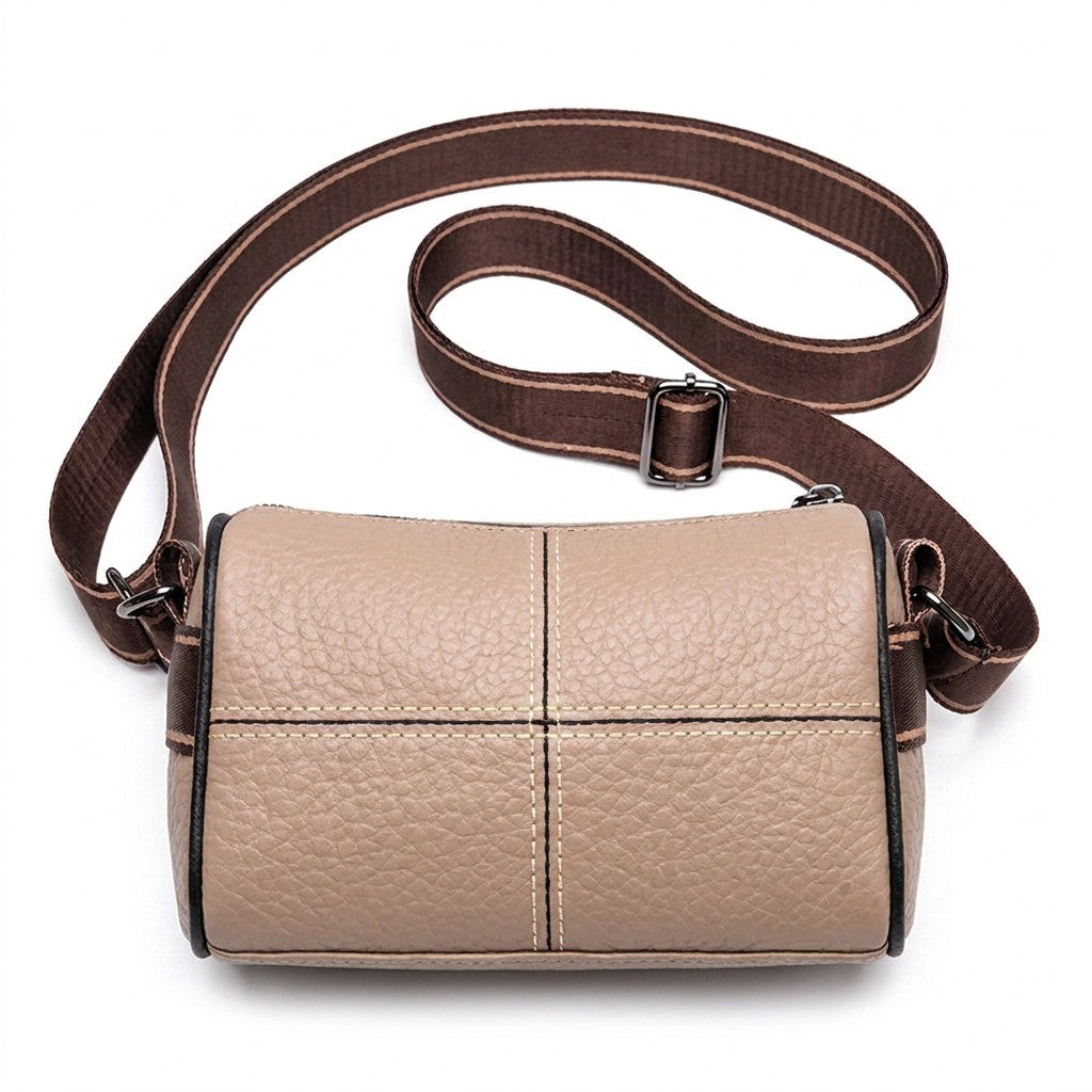 Sandy beige Bellamy crossbody bag with black-piped cross seams and chocolate brown woven strap