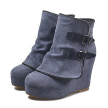 Pair of slate-blue Saskia suede wedge ankle boots on white with navy leather straps