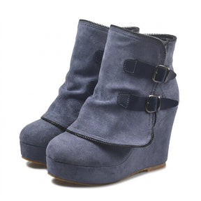 Pair of slate-blue Saskia suede wedge ankle boots on white with navy leather straps