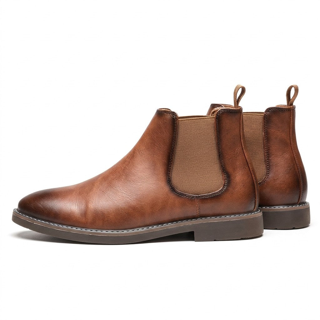Pair of tan Falk Chelsea boots on white showing the elastic side panel