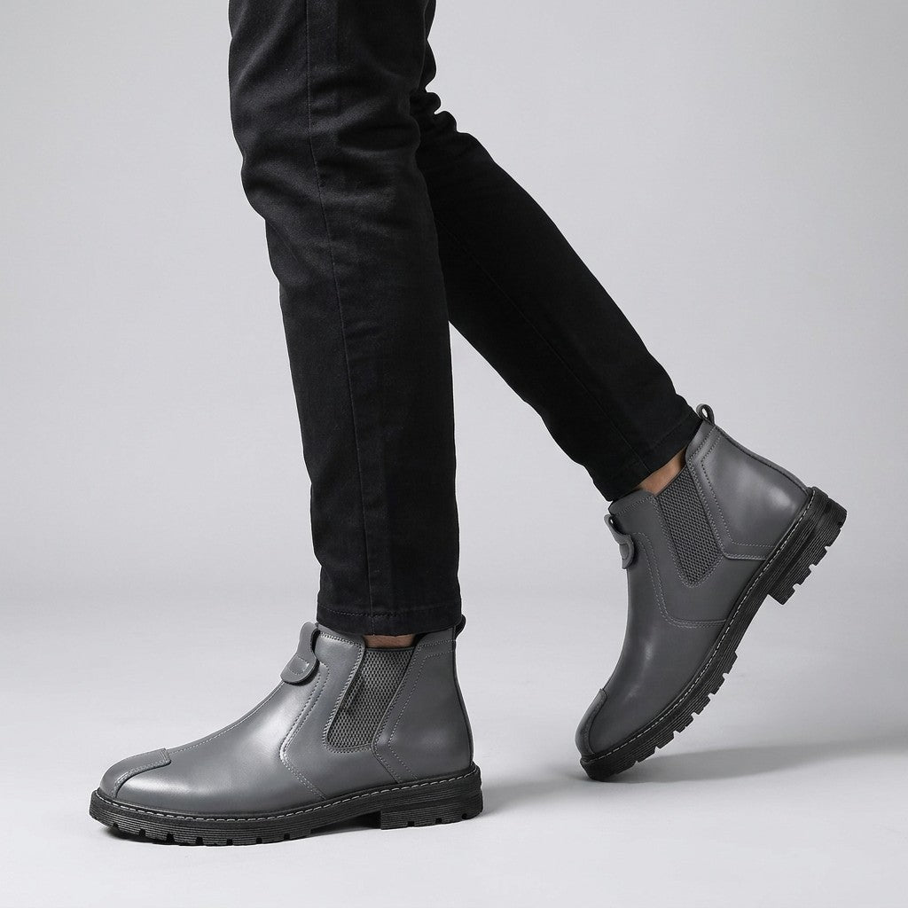 Grey Henrik Chelsea boots worn with black chinos, walking side view