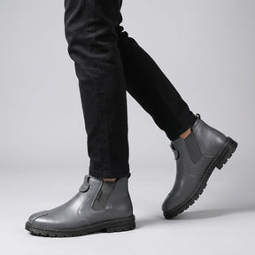 Grey Henrik Chelsea boots worn with black chinos, walking side view
