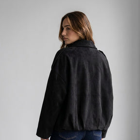 Back view of the Black Brisa suede bomber, model looking over her shoulder