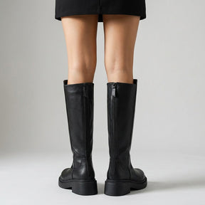 Back view of black Mirabel boots with zip pull tabs and platform heels