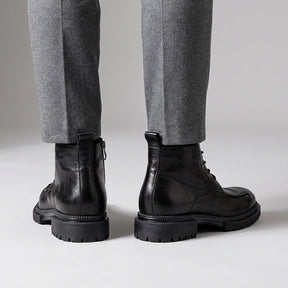 Back view of black Nils boots showing the heel pull loop and inner side zip