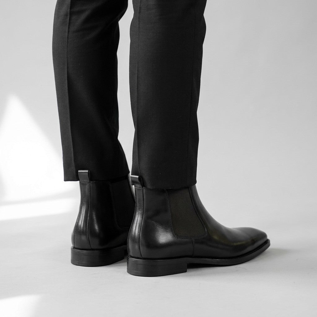 Back view of black Jasper Chelsea boots showing the pull tabs and stacked heels