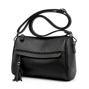 Three-quarter view of the Odalys black barrel bag showing the rounded end and swivel clasp