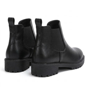 Ines black Chelsea boots from behind on white, back pull loops and lugged heels
