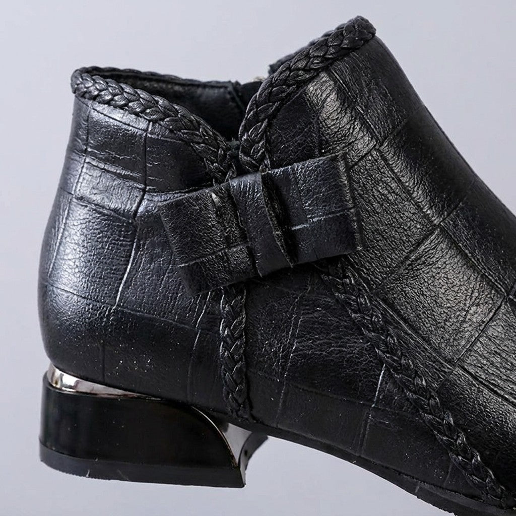 Close-up of the Tamsin folded leather bow, braided piping and silver-banded block heel