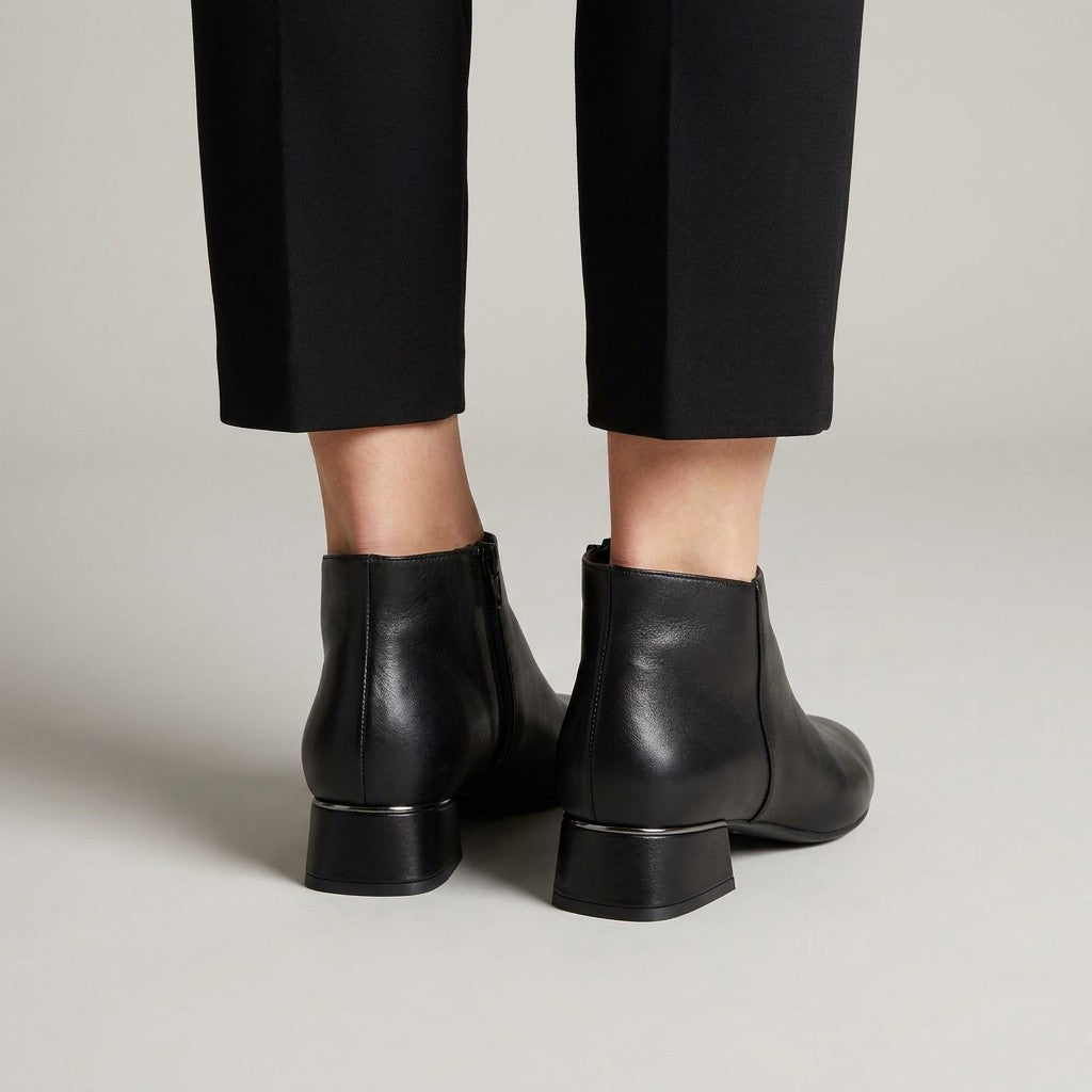 Back view of black Clemence shoe boots showing the inner zip and heel trim