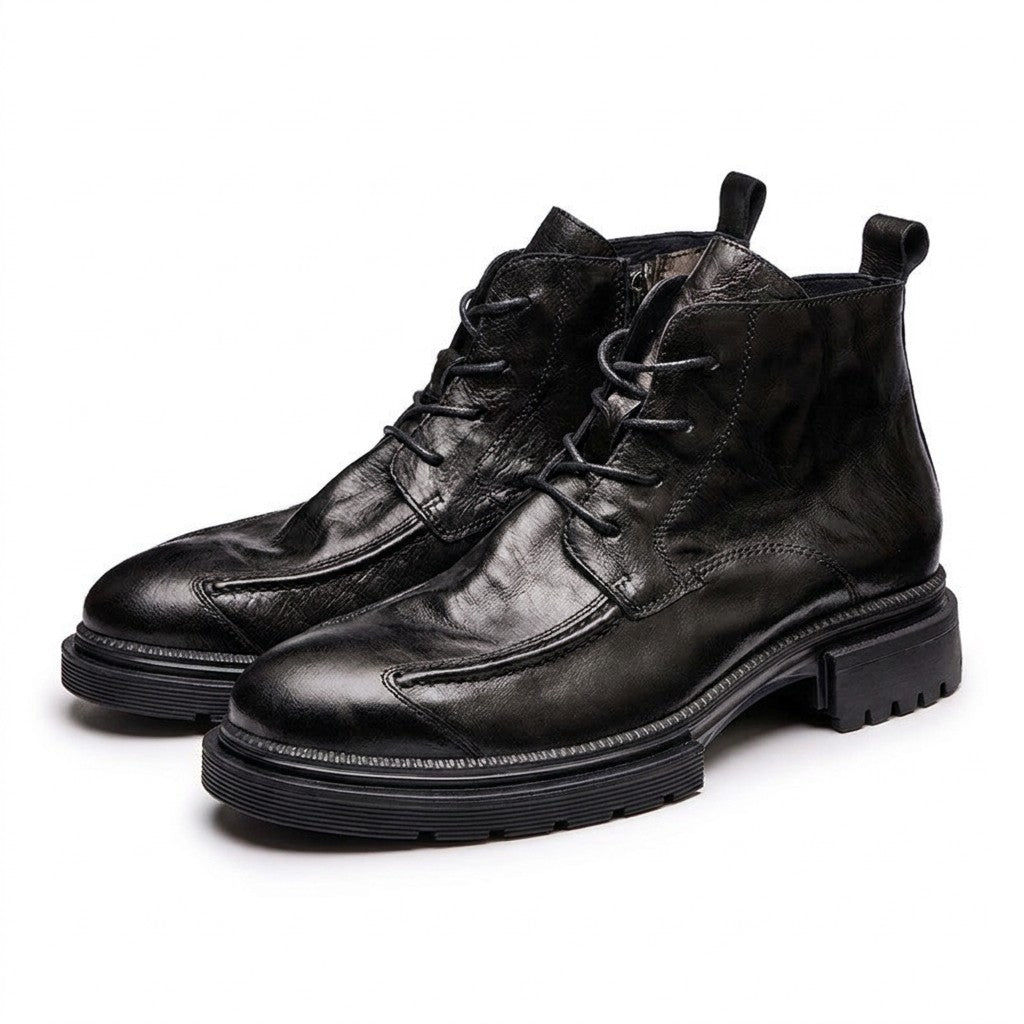 Black Nils boots from the front showing the raised curved apron seam and lacing