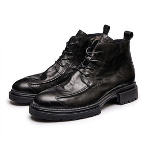 Black Nils boots from the front showing the raised curved apron seam and lacing