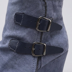 Close-up of the gunmetal buckles and exposed zip-tooth trim on the blue Saskia boot