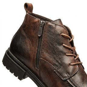 Close-up of the Nils inner side zip, pull loop and burnished brown leather