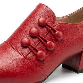 Close-up of the Clemence leather-covered buttons linked by double cords