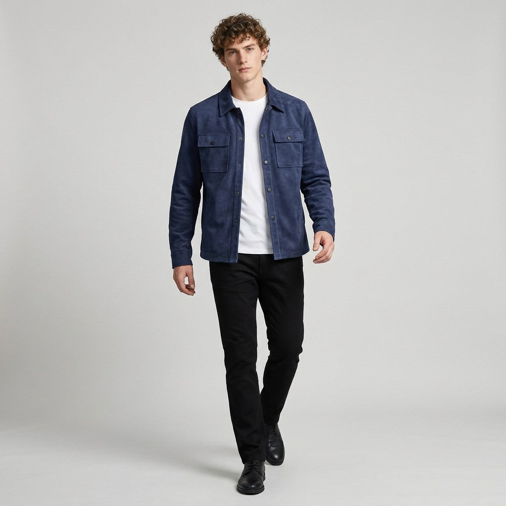 Model walking in the navy Dorian suede shirt jacket worn open with black trousers